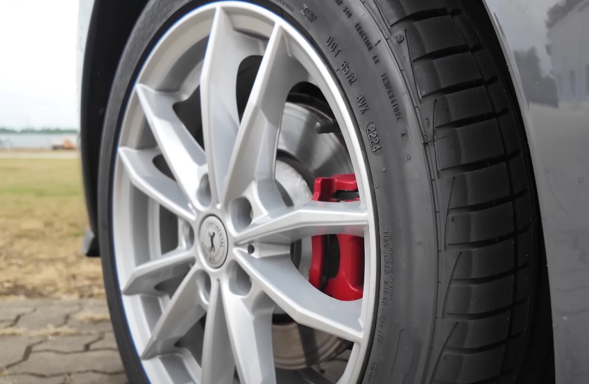 A detailed view of a vehicle's wheel assembly, showcasing the rim and tire